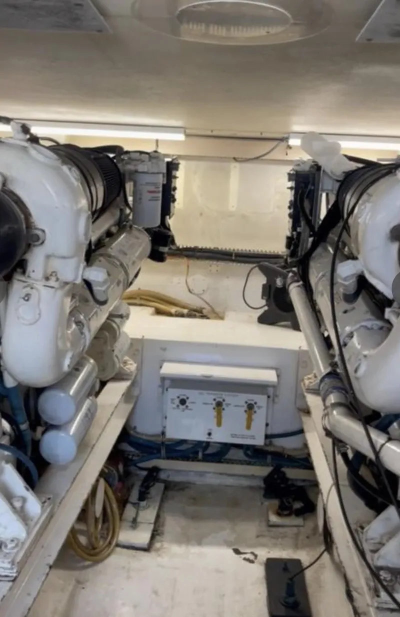 Slide: The Image of Engine room of a 1995 Viking 58 Convertible yacht, showcasing dual engines. - 11