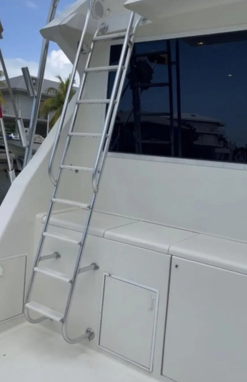 Slide: The Image of 1995 Viking 58 Convertible yacht with exterior ladder and sleek white design. - 3