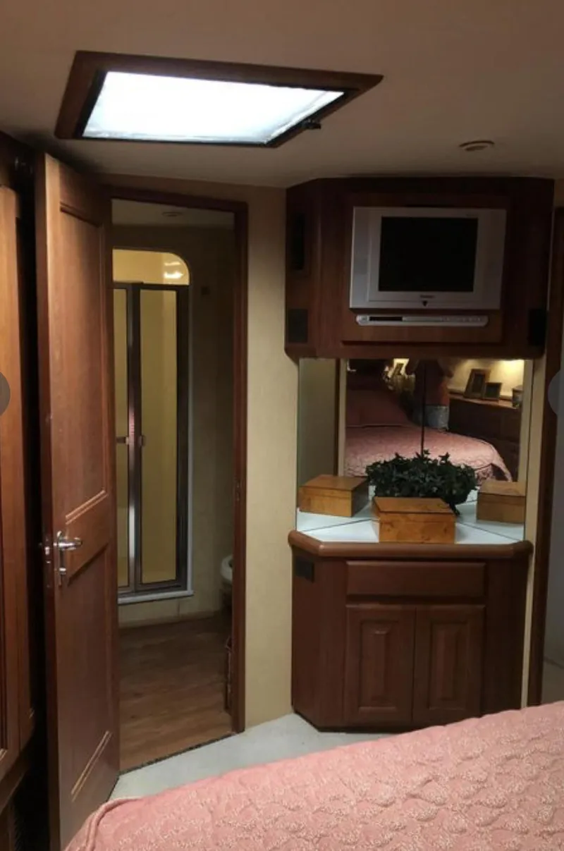 Slide: The Image of Interior of 1995 Viking 58 Convertible yacht with wood cabinetry and TV. - 7