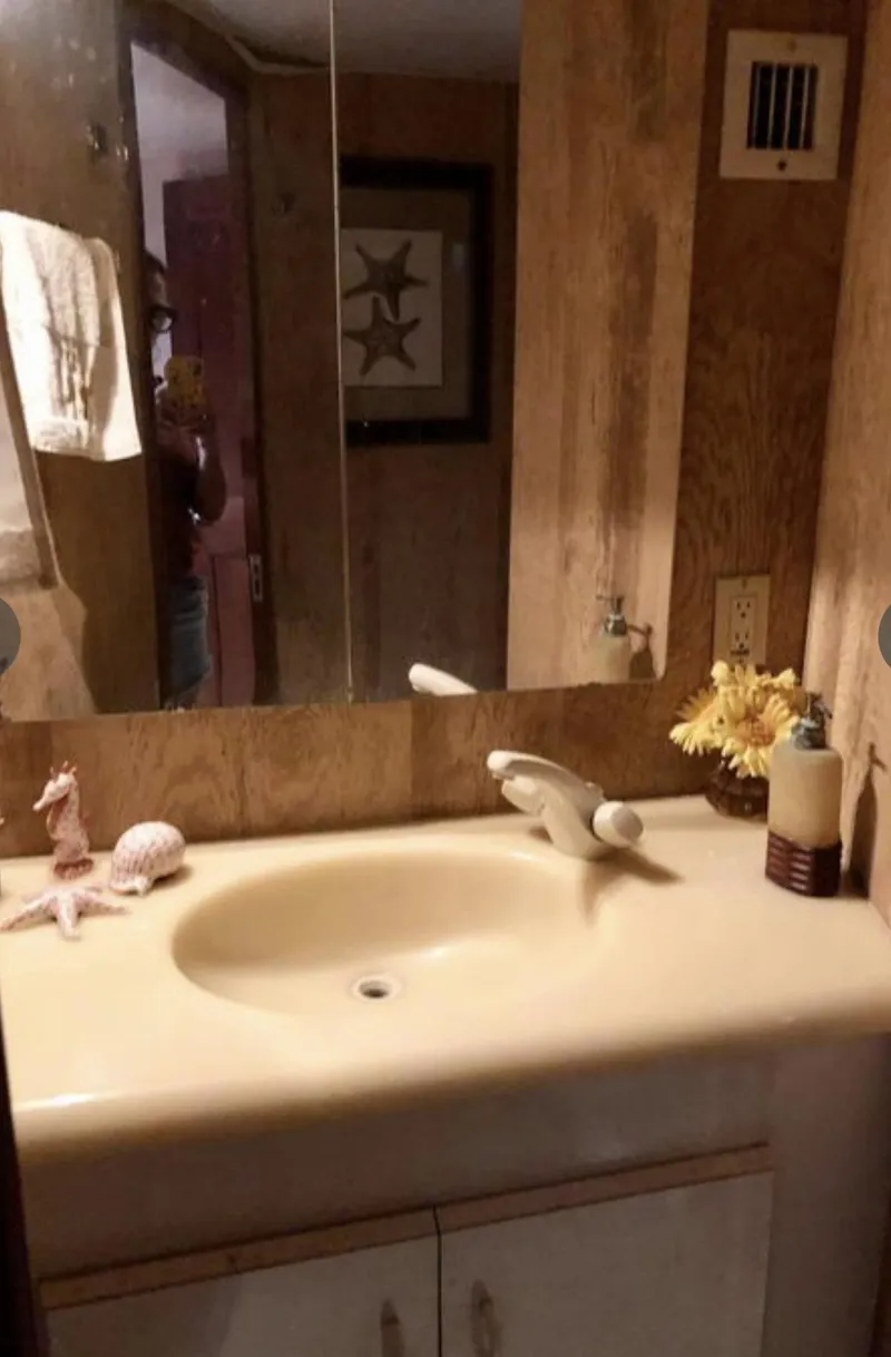 Slide: The Image of Bathroom interior of a 1995 Viking 58 Convertible yacht with beige sink and decorative items. - 8