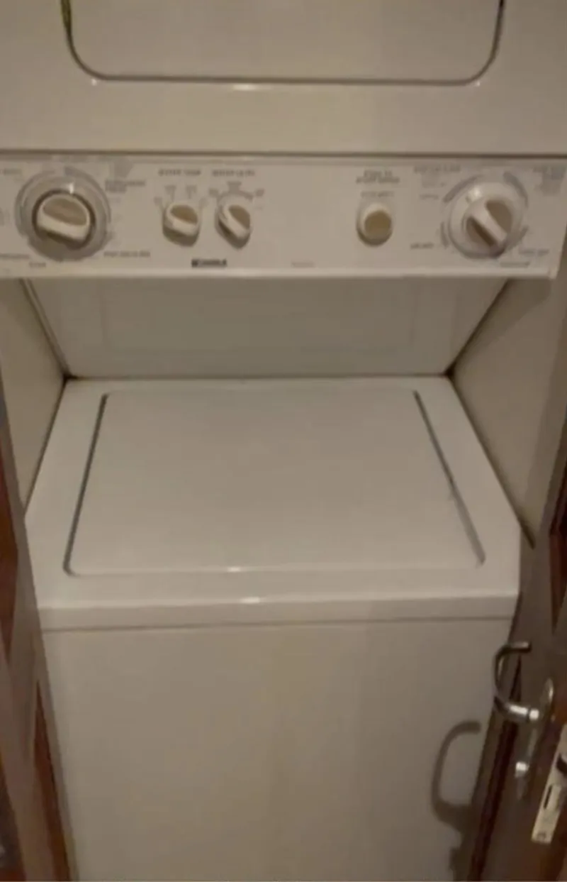 Slide: The Image of Stacked washer and dryer unit inside a 1995 Viking 58 Convertible yacht. - 9
