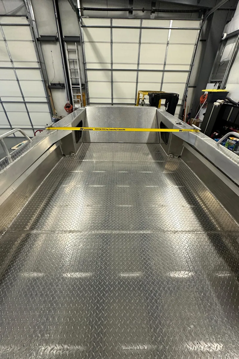 Slide: The Image of 2024 Bayview Boats 26 Landing Craft in a warehouse, showcasing its spacious deck. - 22