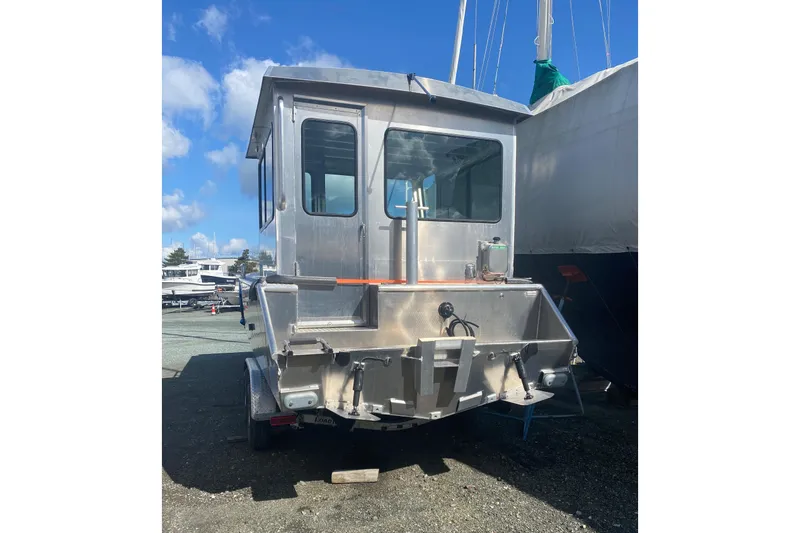 Slide: The Image of 2026 Bayview Boats 26 Landing Craft, rear view, parked outdoors under blue sky. - 26
