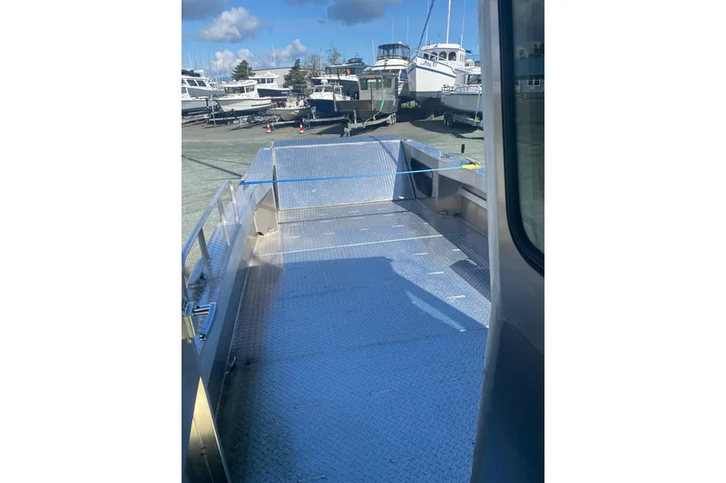 Slide: The Image of Bayview Boats 26 Landing Craft 2026, docked with spacious deck, marina background. - 27