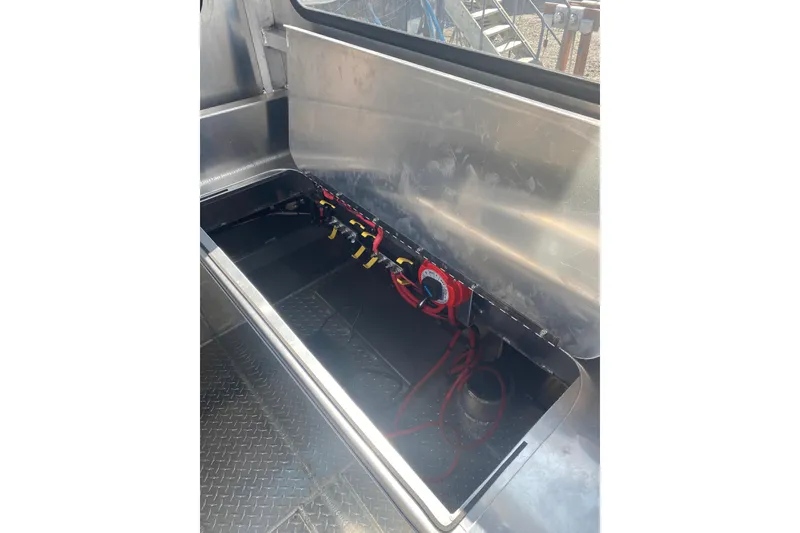 Slide: The Image of Interior view of 2026 Bayview Boats 26 Landing Craft, showcasing storage compartment and wiring. - 29