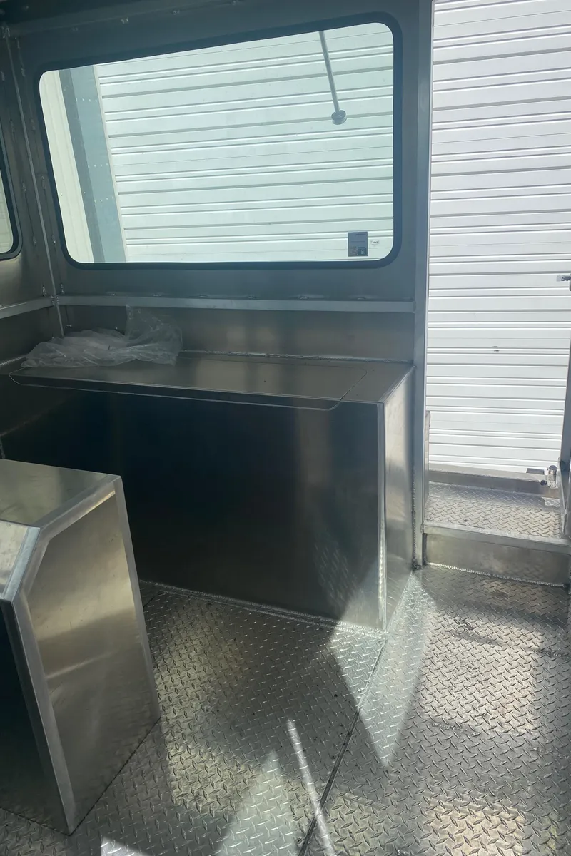 Slide: The Image of Interior of 2024 Bayview Boats 26 Landing Craft with metal flooring and bench. - 7