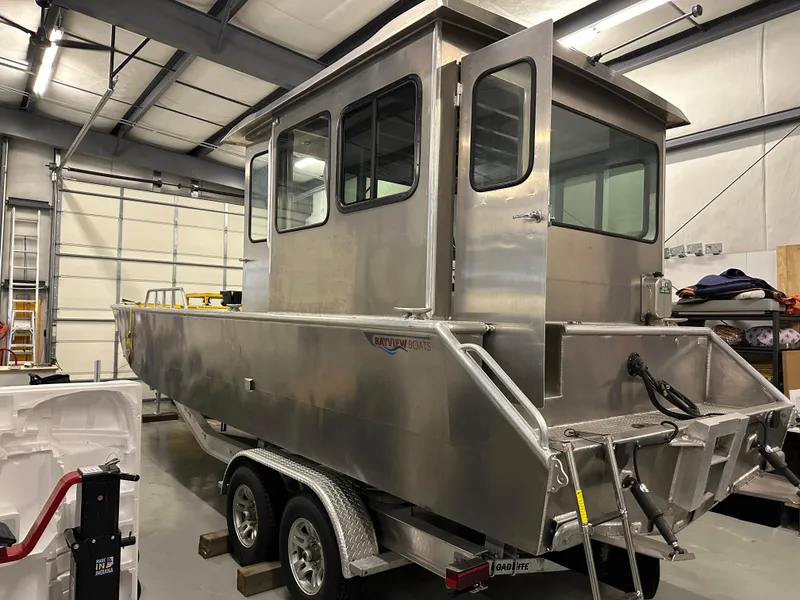 Slide: The Image of 2024 Bayview Boats 26 Landing Craft in a warehouse on a trailer. - 9