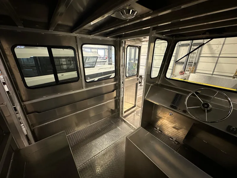 Slide: The Image of Interior of 2024 Bayview Boats 26 Landing Craft, showcasing helm and cabin area. - 16