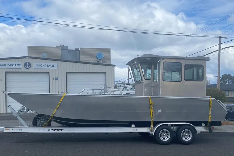 Slide: The Image of 2024 Bayview Boats 26 Landing Craft on trailer outside yacht sales building. - 2