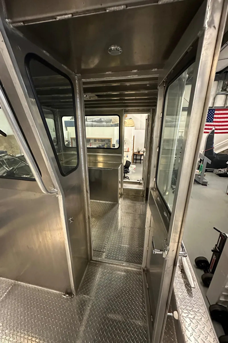 Slide: The Image of Interior of 2024 Bayview Boats 26 Landing Craft with metal flooring and windows. - 24