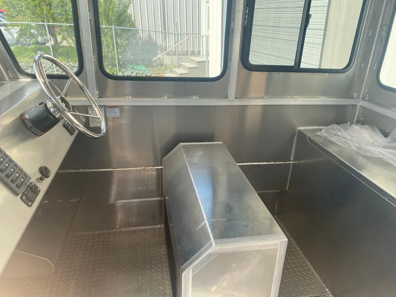 Slide: The Image of Interior of 2024 Bayview Boats 26 Landing Craft, featuring steering wheel and metal seating. - 5