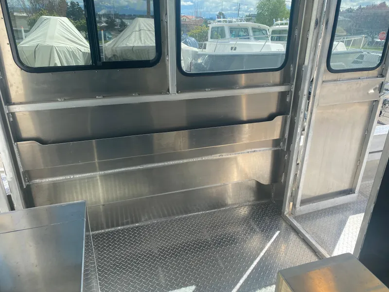 Slide: The Image of Interior of 2024 Bayview Boats 26 Landing Craft with metal flooring and windows. - 6