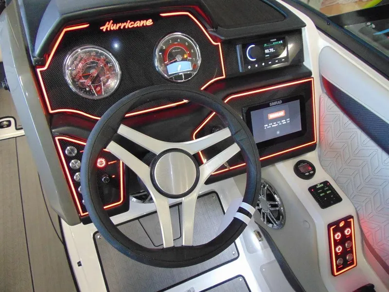 Slide: The Image of 2024 Hurricane SunDeck 2600 OB boat dashboard with illuminated controls and modern steering wheel. - 10
