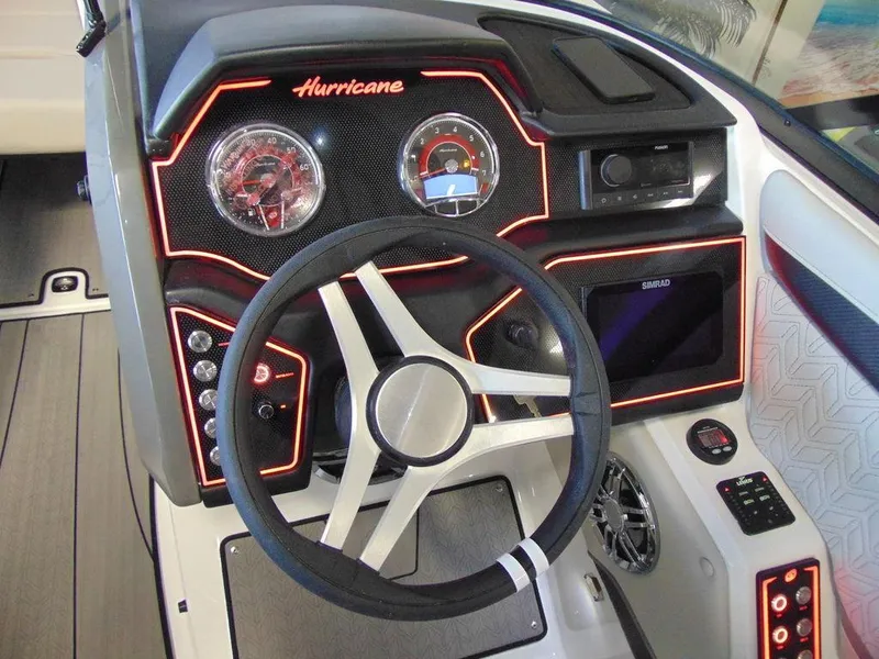 Slide: The Image of 2024 Hurricane SunDeck 2600 OB boat dashboard with illuminated controls and steering wheel. - 11