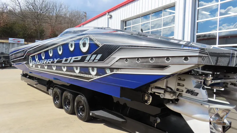 Slide: The Image of 2020 Outerlimits 46SC speedboat on a trailer, featuring a sleek blue and silver design. - 10