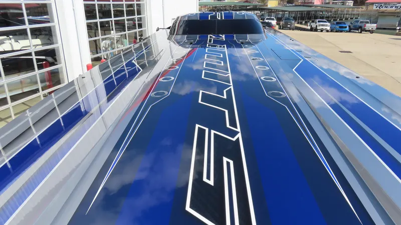 Slide: The Image of 2020 Outerlimits 46SC speedboat with sleek blue and white design. - 11