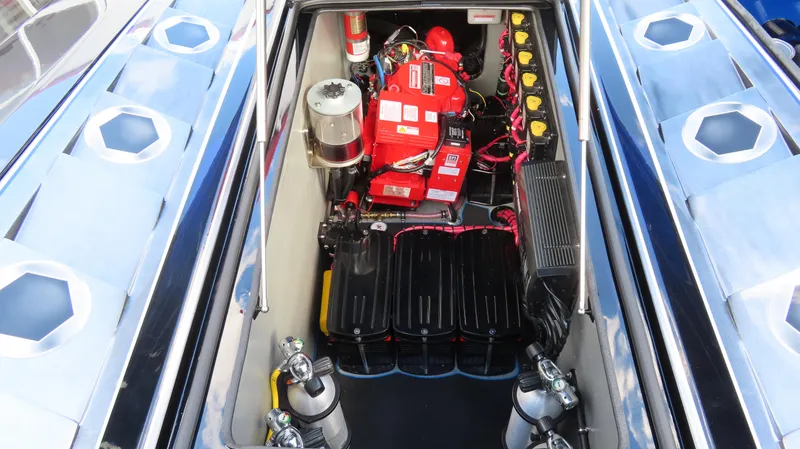 Slide: The Image of Engine compartment of a 2020 Outerlimits 46SC boat with batteries and fire extinguisher. - 16