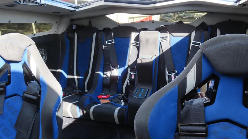 Slide: The Image of Interior of a 2020 Outerlimits 46SC boat with blue and black racing seats. - 20