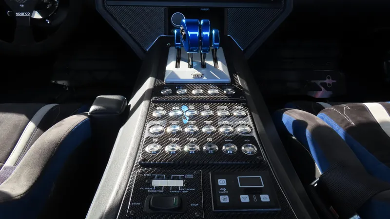 Slide: The Image of Control panel of a 2020 Outerlimits 46SC speedboat with carbon fiber finish. - 26