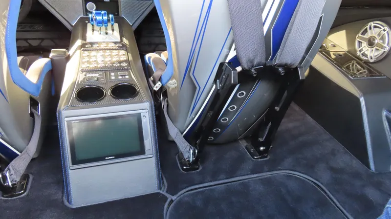 Slide: The Image of Interior of a 2020 Outerlimits 46SC boat with control panel and seating. - 28