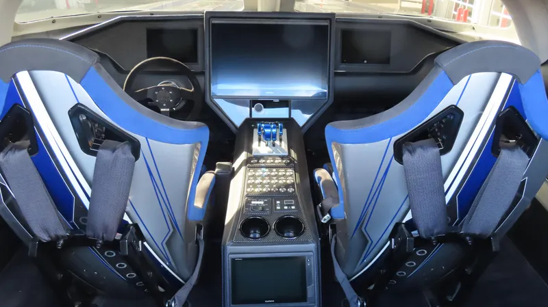 Slide: The Image of 2020 Outerlimits 46SC cockpit with advanced controls and dual blue racing seats. - 29