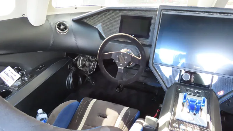 Slide: The Image of Interior cockpit of a 2020 Outerlimits 46SC speedboat with modern controls and steering wheel. - 32