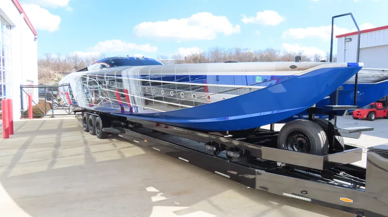 Slide: The Image of 2020 Outerlimits 46SC powerboat on a trailer, blue and silver exterior. - 4