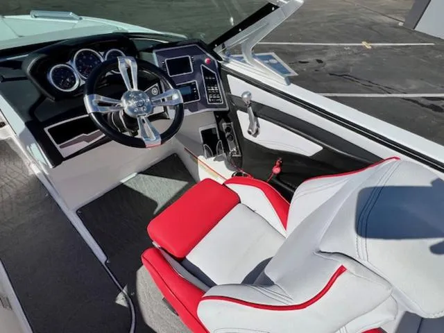 Slide: The Image of 2018 MasterCraft XT22 boat cockpit with red and white captain's seat and modern dashboard. - 11