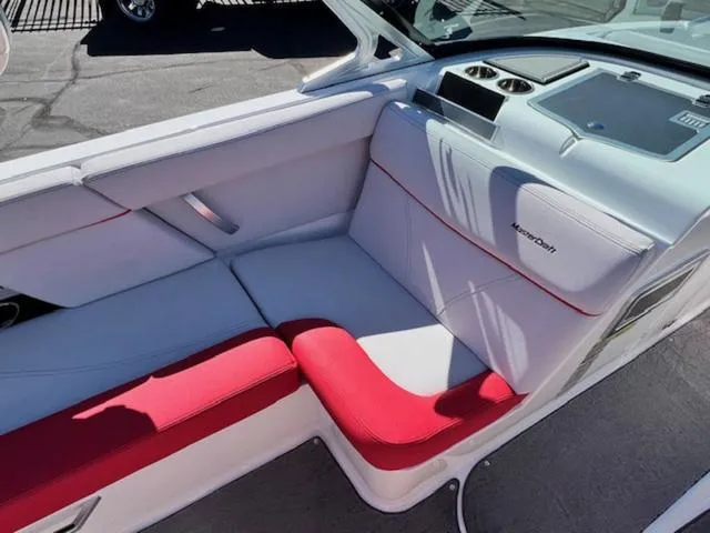 Slide: The Image of 2018 MasterCraft XT22 boat interior with white and red seating. - 12