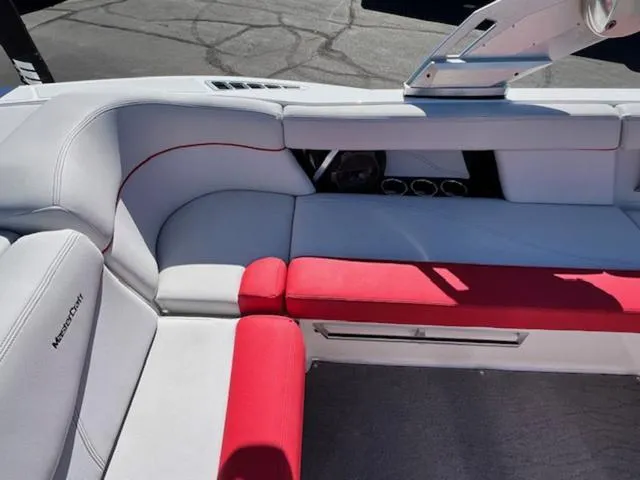 Slide: The Image of 2018 MasterCraft XT22 boat interior with red and white seating. - 13