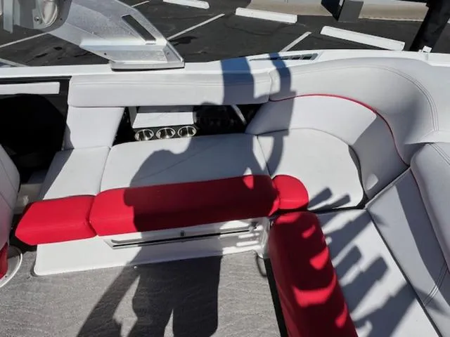 Slide: The Image of 2018 MasterCraft XT22 boat interior with white and red seating. - 15