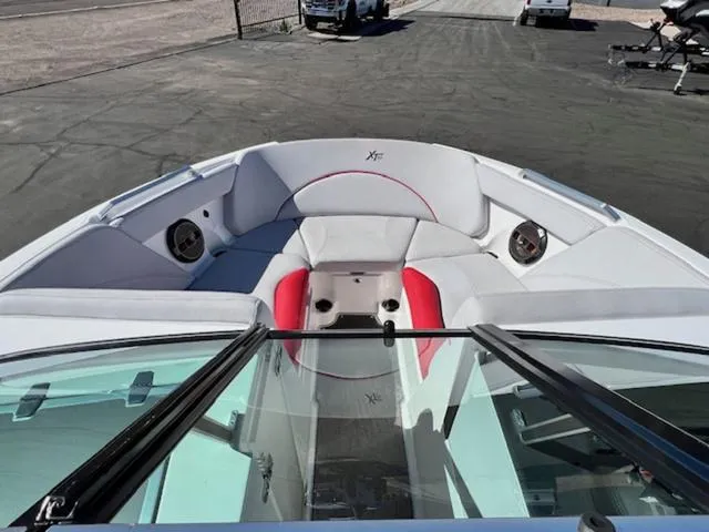 Slide: The Image of 2018 MasterCraft XT22 boat interior with white and red seating. - 16