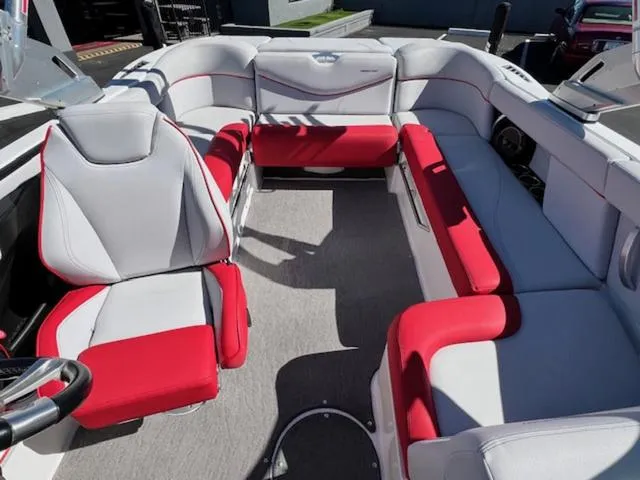 Slide: The Image of 2018 MasterCraft XT22 boat interior with red and white seating. - 17