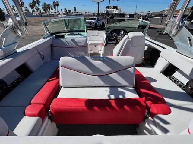 Slide: The Image of 2018 MasterCraft XT22 boat interior with red and white seating. - 18