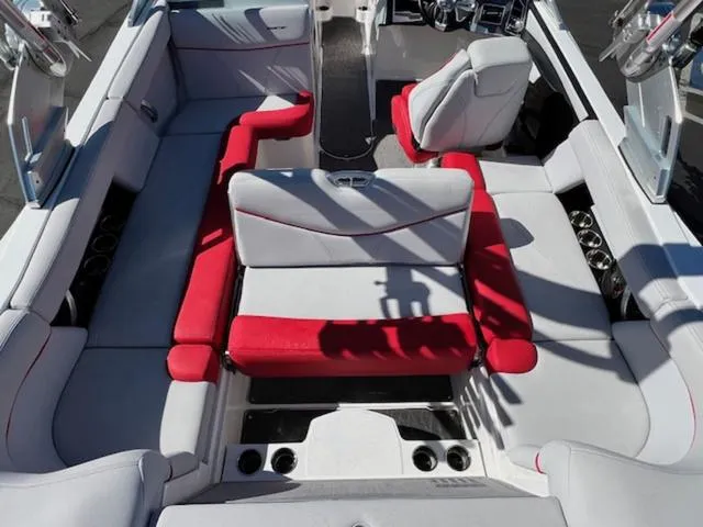Slide: The Image of 2018 MasterCraft XT22 boat interior with red and white seating. - 19