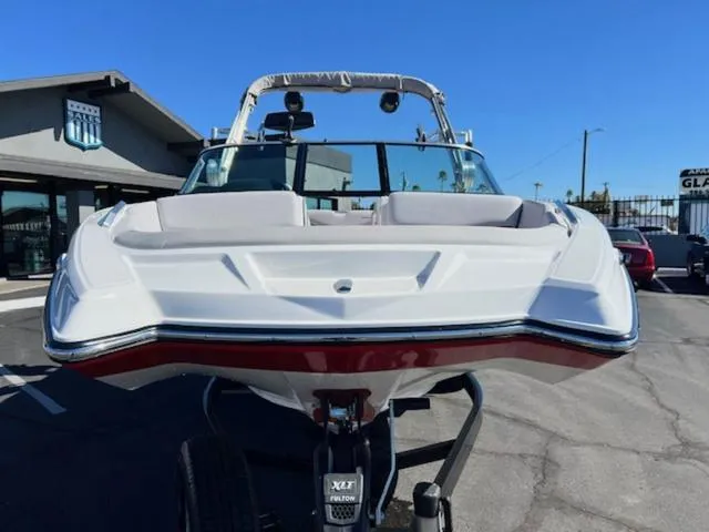 Slide: The Image of 2018 MasterCraft XT22 boat on trailer, front view, parked outdoors. - 3