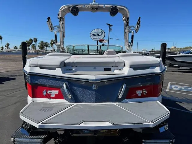 Slide: The Image of 2018 MasterCraft XT22 boat rear view at a marina. - 7