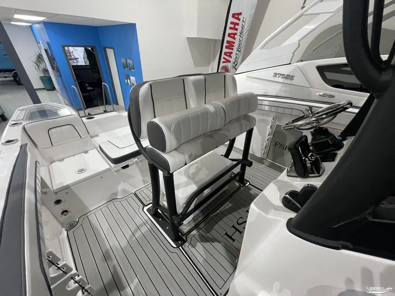 Slide: The Image of 2024 Yamaha Boats 255 FSH Sport H interior with sleek seating and modern controls. - 11