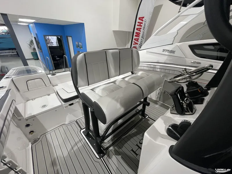 Slide: The Image of 2024 Yamaha Boats 255 FSH Sport H interior with sleek seating and modern controls. - 12