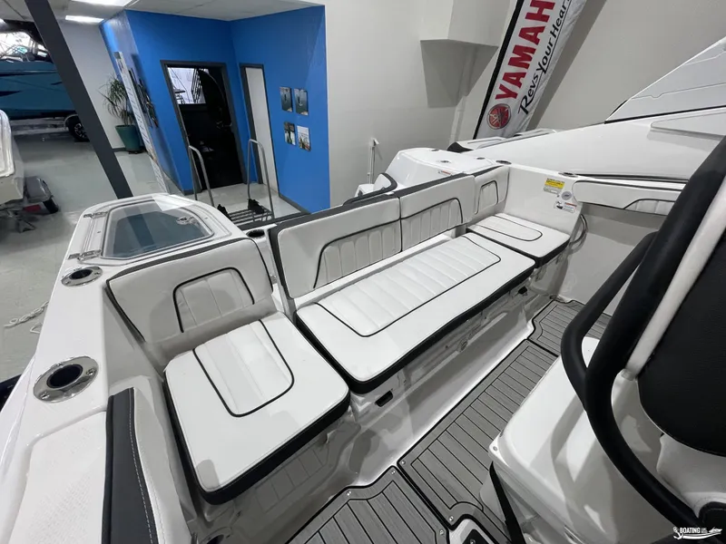 Slide: The Image of 2024 Yamaha Boats 255 FSH Sport H interior with white seating and modern design. - 14