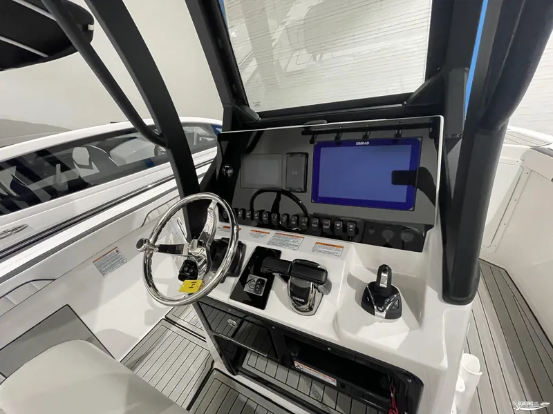 Slide: The Image of 2024 Yamaha Boats 255 FSH Sport H dashboard with steering wheel and navigation controls. - 16