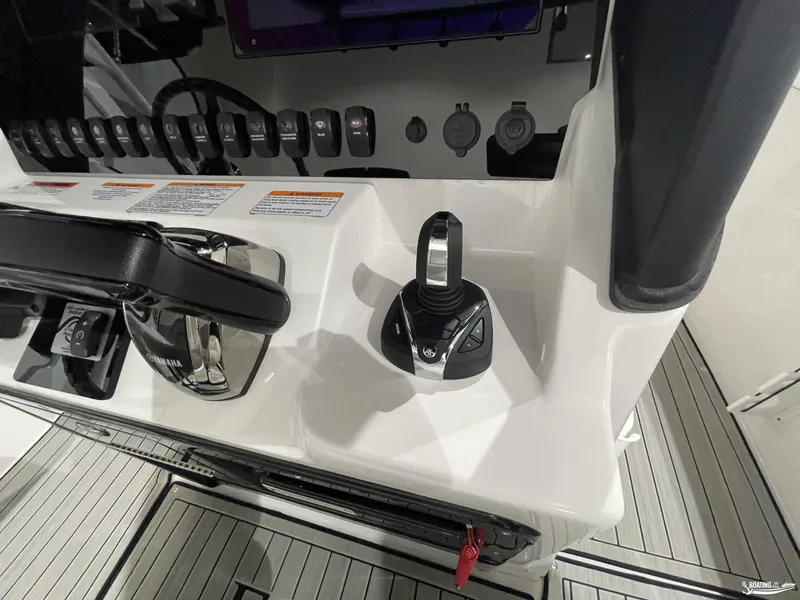Slide: The Image of 2024 Yamaha Boats 255 FSH Sport H control panel with joystick and switches. - 17