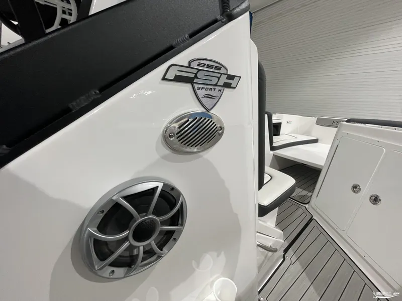 Slide: The Image of 2024 Yamaha Boats 255 FSH Sport H interior with speaker and seating detail. - 18