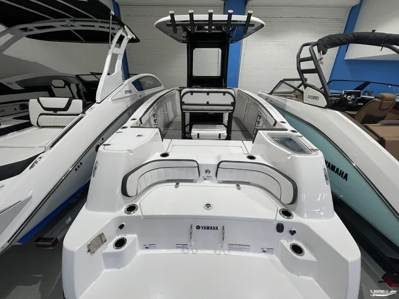 Slide: The Image of 2024 Yamaha Boats 255 FSH Sport H, sleek white design in showroom. - 3
