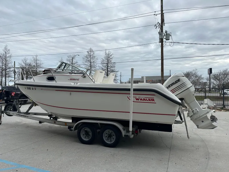 Slide: The Image of 1998 Boston Whaler 23 Conquest boat on a trailer with Evinrude outboard motor. - 20