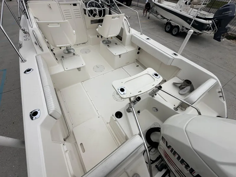 Slide: The Image of 1998 Boston Whaler 23 Conquest boat interior with seating and Evinrude outboard motor. - 23