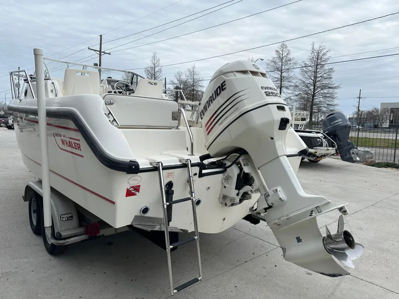 Slide: The Image of 1998 Boston Whaler 23 Conquest boat with Evinrude outboard motor on trailer. - 3