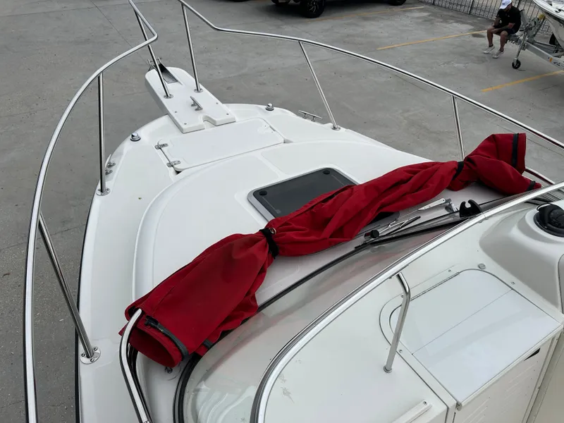 Slide: The Image of 1998 Boston Whaler 23 Conquest boat deck with red cover. - 32