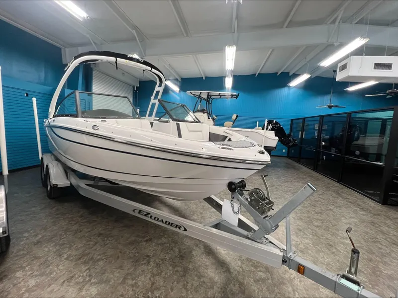 Slide: The Image of 2019 Bryant Speranza boat on trailer in showroom with blue walls. - 2