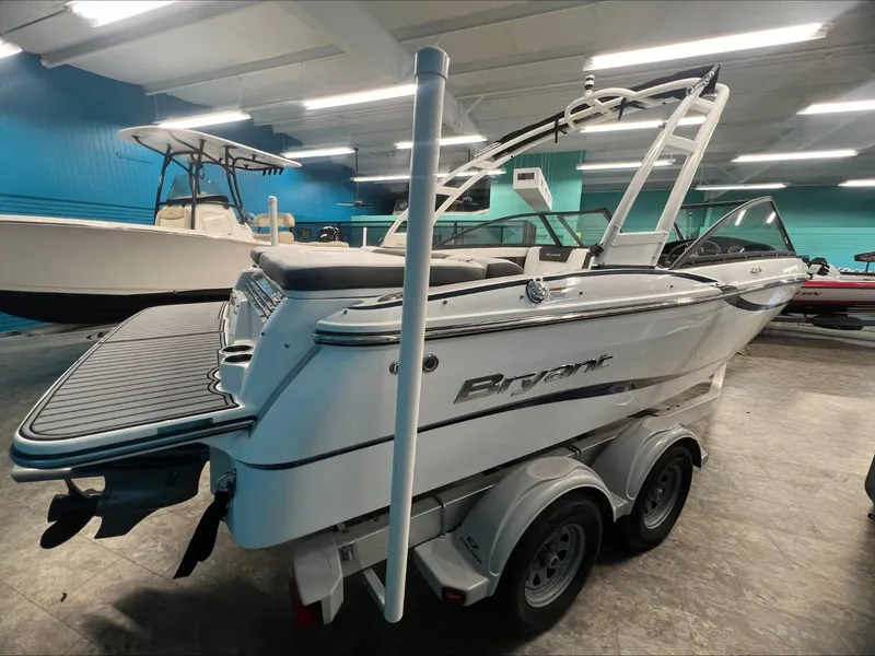 Slide: The Image of 2019 Bryant Speranza boat on trailer in showroom, sleek design, white exterior. - 3